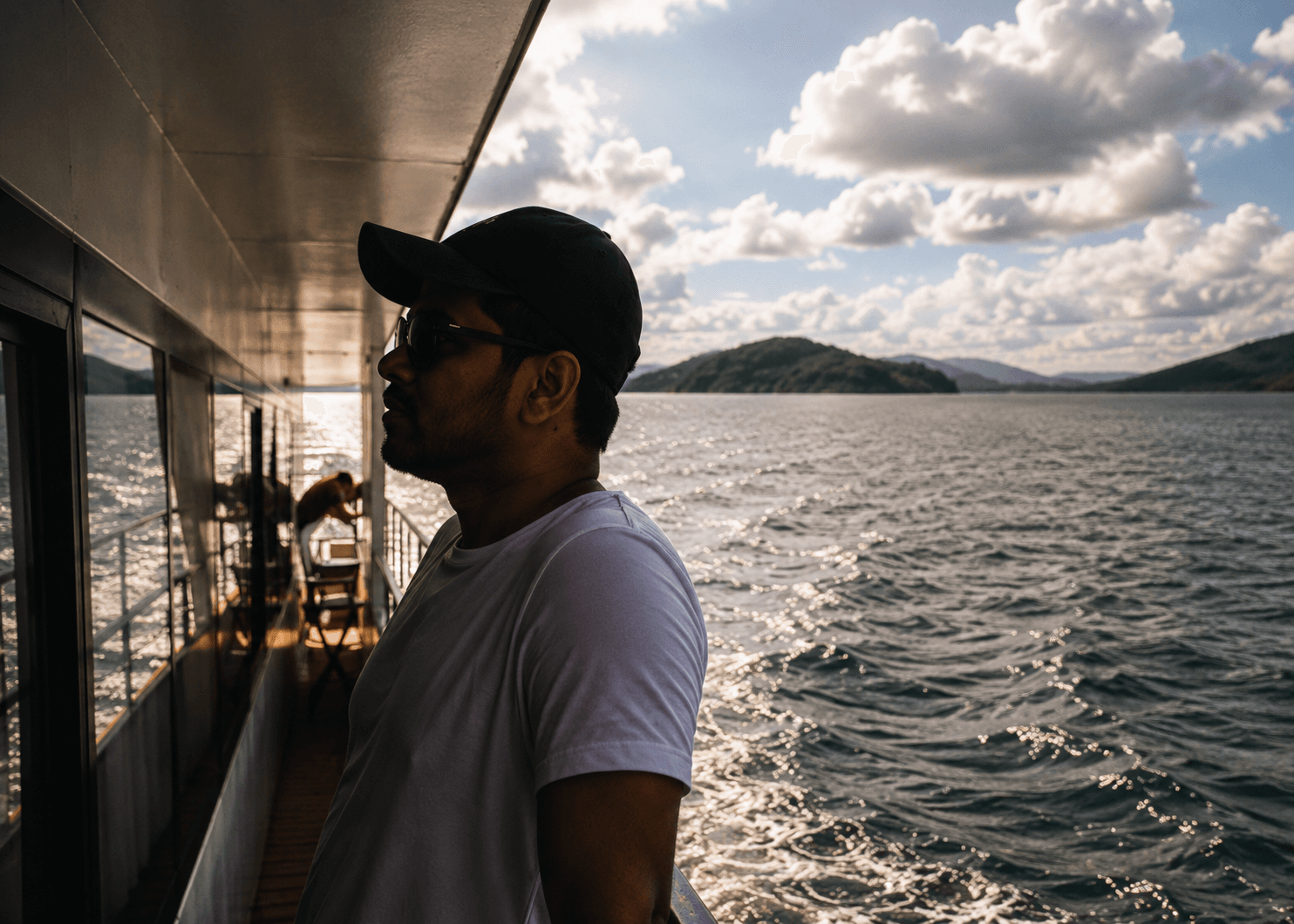 Manas Majhi on a ferry deck looking out at islands