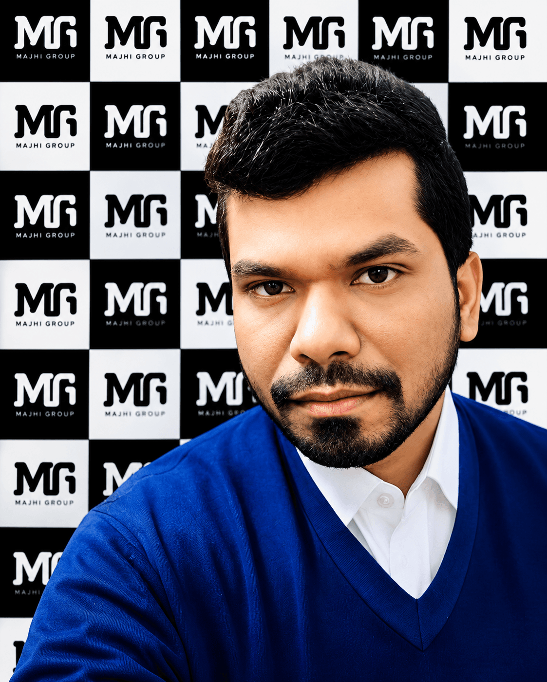 Manas Majhi in a blue sweater in front of the Majhi Group branded backdrop