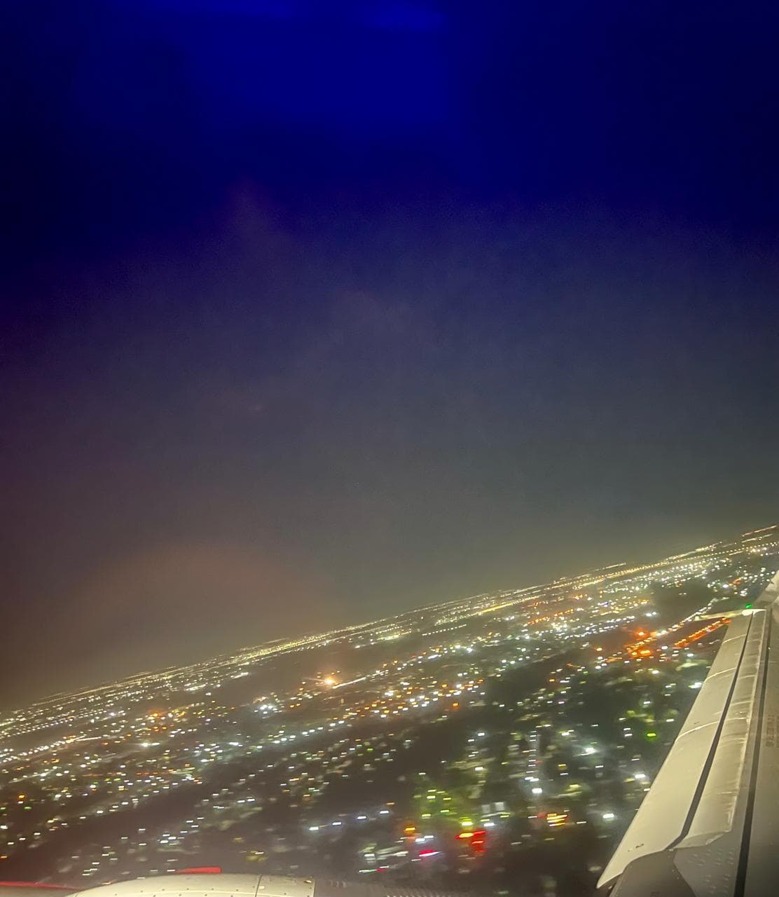 Aerial night view of a city from a plane window — Manas Majhi