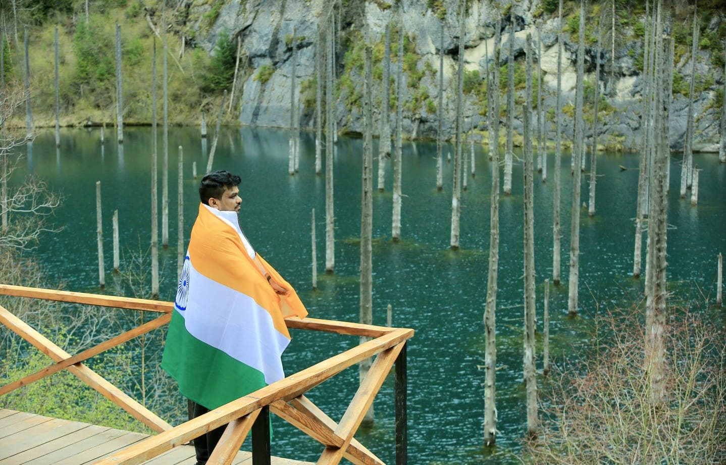 Manas Majhi draped in the Indian flag at a submerged forest lake