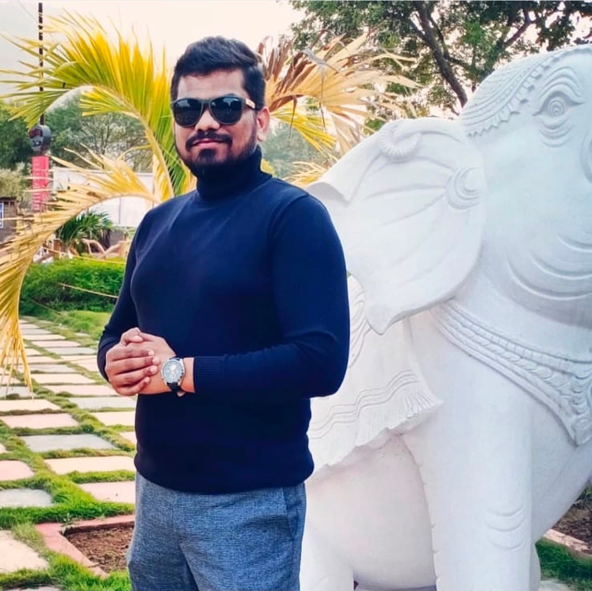 Manas Majhi beside a white marble elephant sculpture